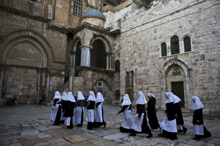 A group of nuns walk in a line into the Church of the Holy Sepulchre in Jerusalem's Old City, April 13, 2015.