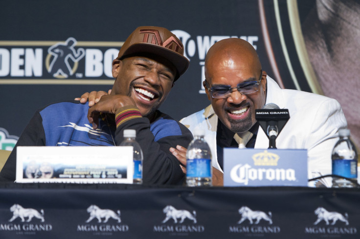 WBC welterweight champion Floyd Mayweather Jr. (L) of the U.S. laughs with Mayweather Promotions CEO Leonard Ellerbe