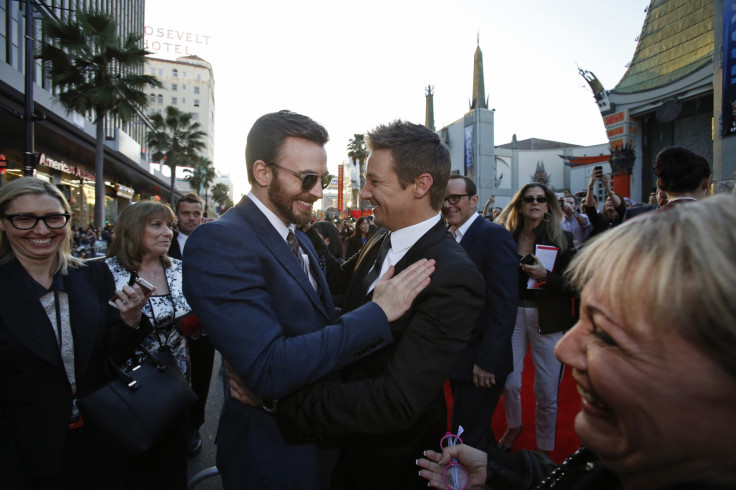 Cast member Chris Evans (L) and actor Jeremy Renner greet each other at the premiere of "Captain America: The Winter Soldier" 