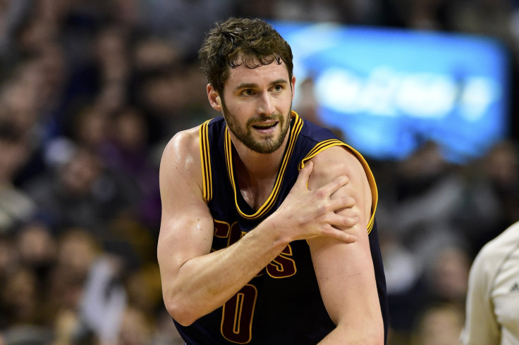 Kevin Love reacts after injuring his shoulder.