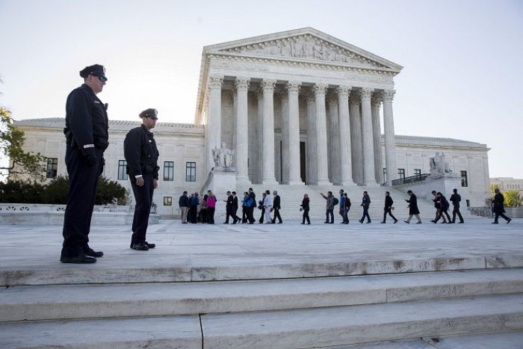 Police watch as members of the public enter the Supreme Court 