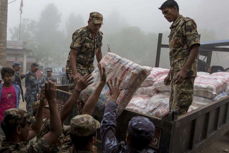 Nepal military personnel load relief supplies onto a truck