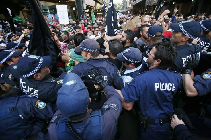 Protesters clash with policemen on a street in Sydney's central business district