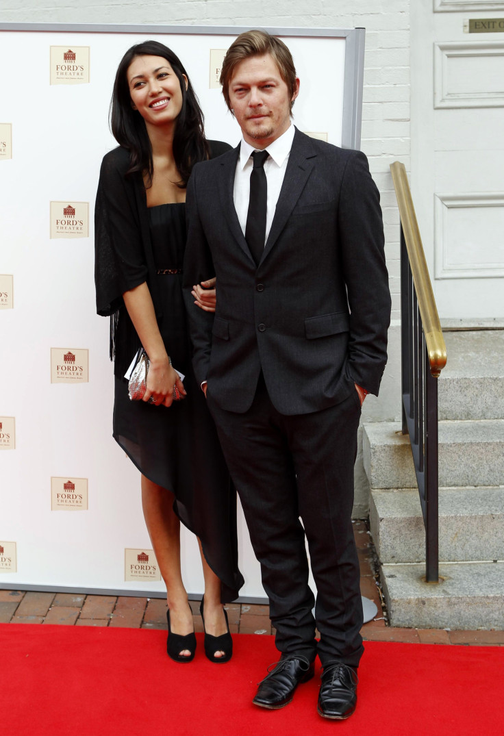 IN PHOTO: Cast member Norman Reedus (R) arrives with an unidentified guest for the premiere of the film "The Conspirator" at Ford's Theatre in Washington April 10, 2011. The film is directed by Robert Redford.   