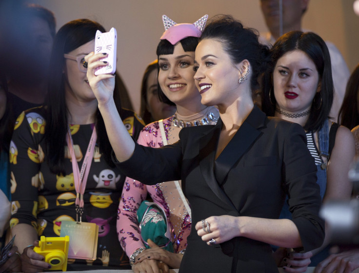 IN PHOTO Singer Katy Perry takes a selfie with a fan at the premiere screening of "Katy Perry: The Prismatic World Tour" in Los Angeles, California March 26, 2015. 