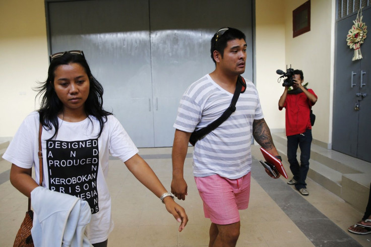 Michael Chan (C), brother of Australian death row prisoner Andrew Chan, leaves with Febyanti Herewila (L)