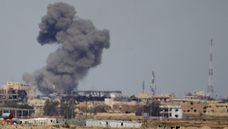 A plume of smoke rises above a building during an air strike 