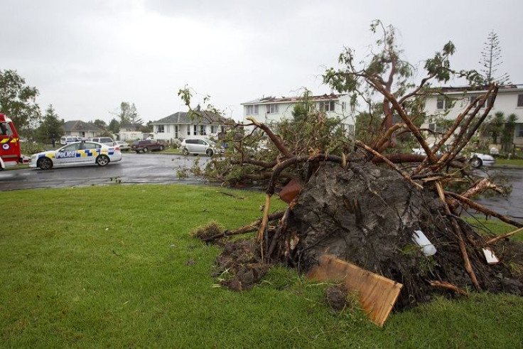 Police patrol the roads amid the devastation in the suburb of Hobsonville after a tornado 