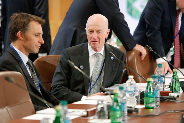 Reserve Bank of Australia (RBA) Governor Glenn Stevens (C) takes his seat for a meeting 