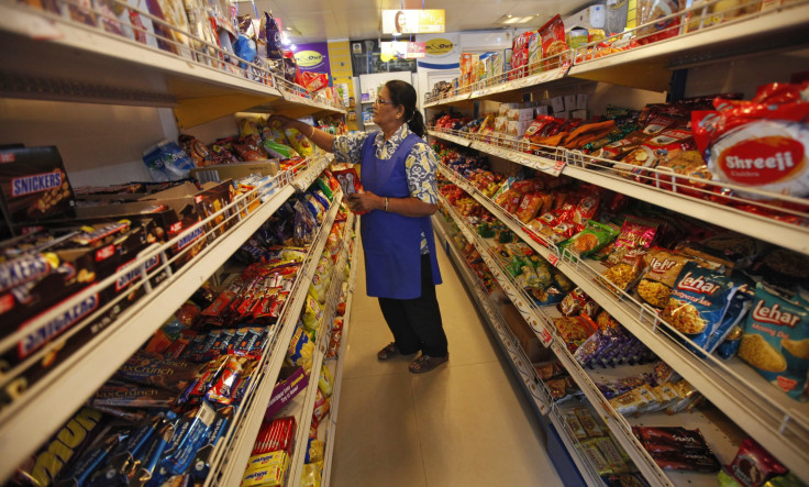 IN PHOTO: A worker arranges food packets inside a retail store in Kolkata October 24, 2013.