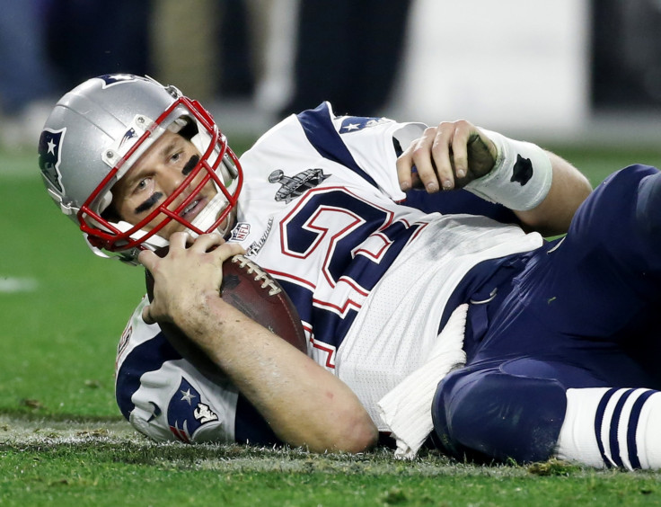 New England Patriots quarterback Tom Brady gets up after being sacked