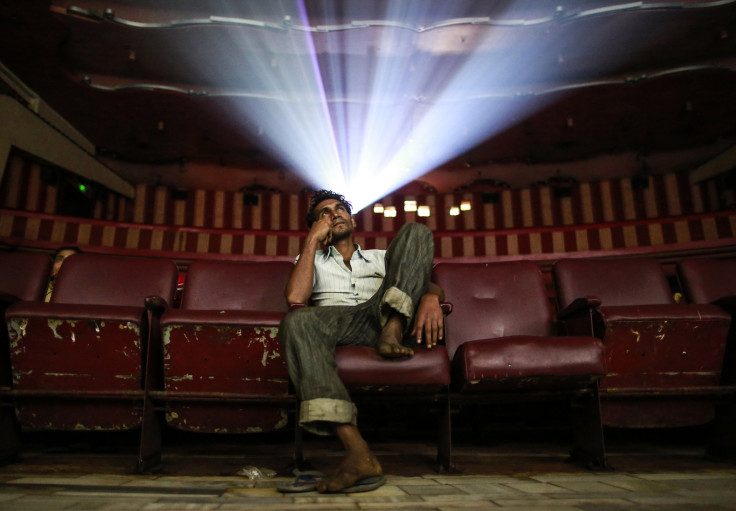 A cinema goer watches Bollywood movie "Dilwale Dulhania Le Jayenge" (The Big Hearted Will Take the Bride), starring actor Shah Rukh Khan, inside Maratha Mandir theatre in Mumbai December 11, 2014.