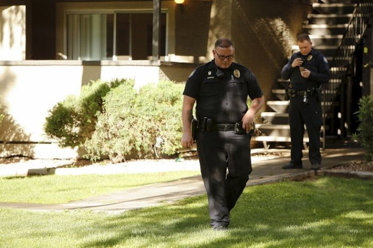 Police officers guard the area around the Autumn Ridge apartment complex