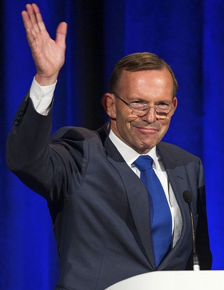 Australian Prime Minister Tony Abbott (L) gestures during a joint news conference 