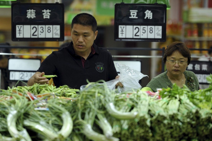 Customers select vegetables at a supermarket in Fuyang, Anhui province, China, May 9, 2015.