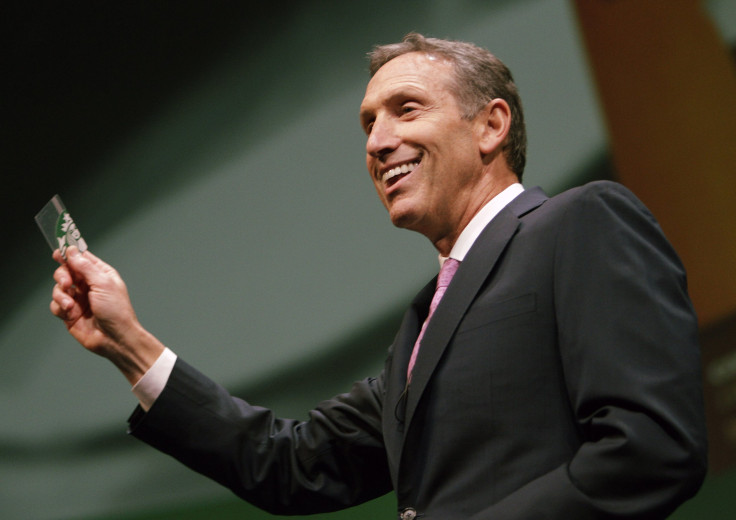 Starbucks CEO Howard Schultz holds up a Starbucks Card as he speaks to shareholders at the company's annual meeting of shareholders in Seattle, Washington March 23, 2011. 
