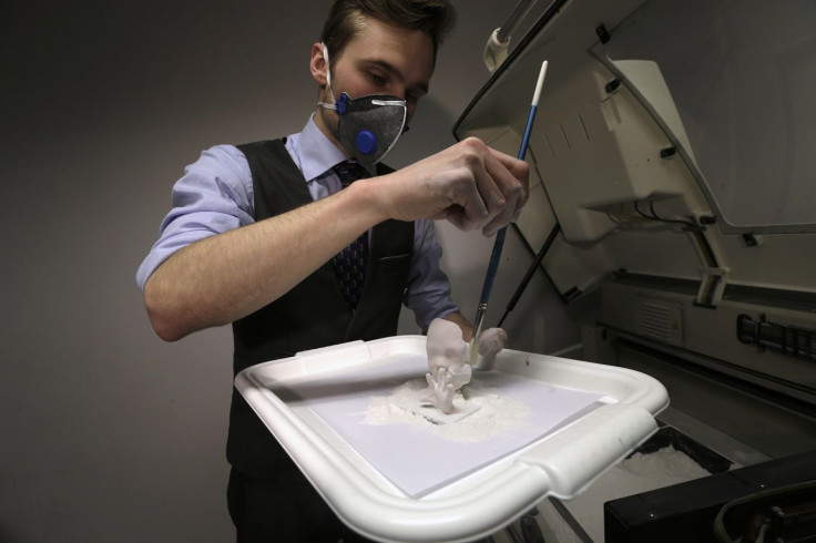 Haver Jarveoja cleans a three-dimensional (3D) print model of an unborn baby in Tallinn January 28, 2015.