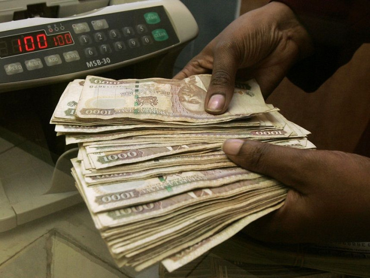 A currency dealer counts Kenya shillings at a money exchange counter in Nairobi October 23, 2008.
