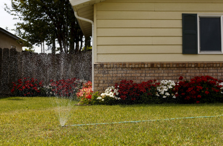 IN PHOTO: A lawn is watered in Livingston, California April 21, 2015. California water regulators have adopted the state's first rules for mandatory cutbacks in urban water use as the region's catastrophic drought enters its fourth year.
