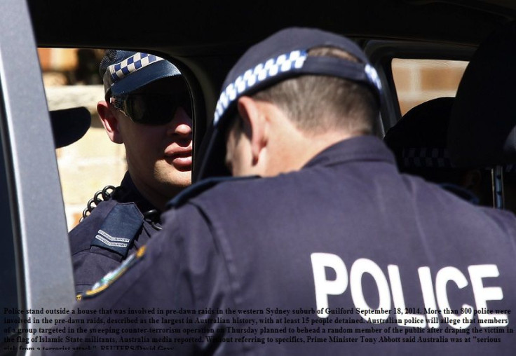 Police stand outside a house that was involved in pre-dawn raids in the western Sydney suburb of Guilford September 18, 2014.