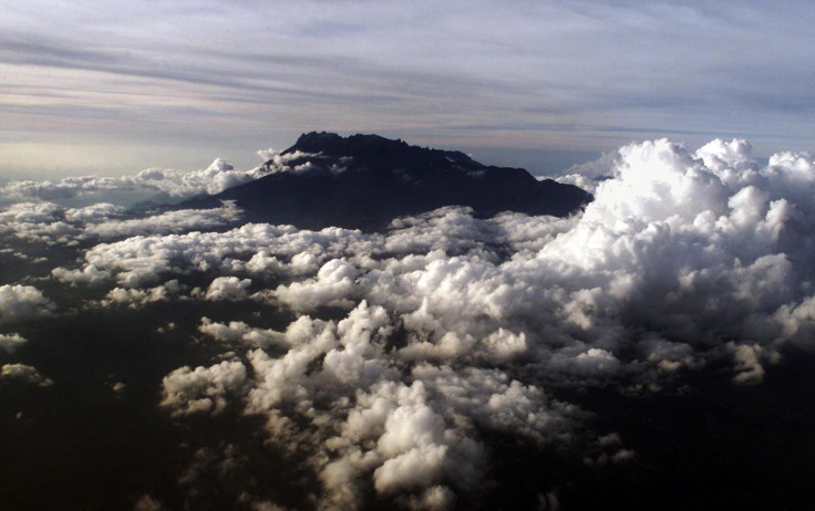 IN PHOTO: Mount Kinabalu appears through the clouds over Kota Kinabalu, capital of the east Malaysian state of Sabah on Borneo island, in this March 8, 2002 aerial photograph.