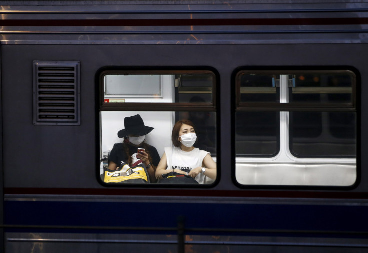 IN PHOTO: Women wearing masks to prevent contracting Middle East Respiratory Syndrome (MERS) ride a subway train in Seoul, South Korea, June 12, 2015.