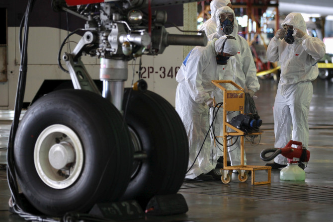 IN PHOTO: Crew members of Thai Airways prepare to disinfect the cabin of an aircraft of the national carrier at Bangkok's Suvarnabhumi International Airport, Thailand, June 18, 2015