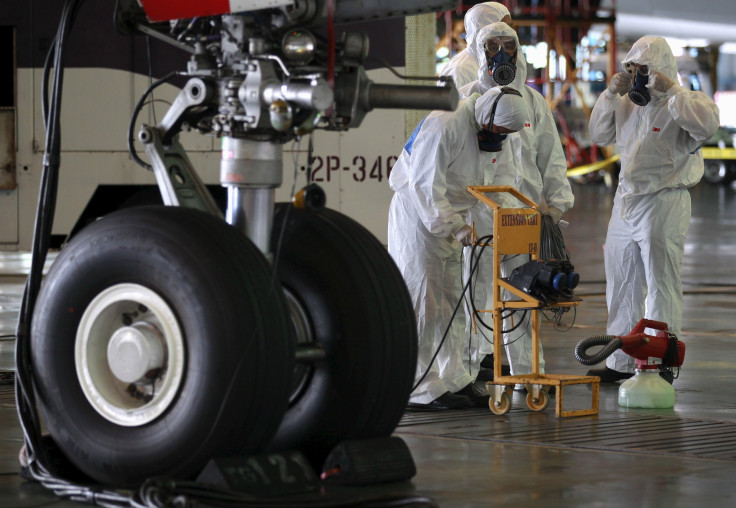 IN PHOTO: Crew members of Thai Airways prepare to disinfect the cabin of an aircraft of the national carrier at Bangkok's Suvarnabhumi International Airport, Thailand, June 18, 2015