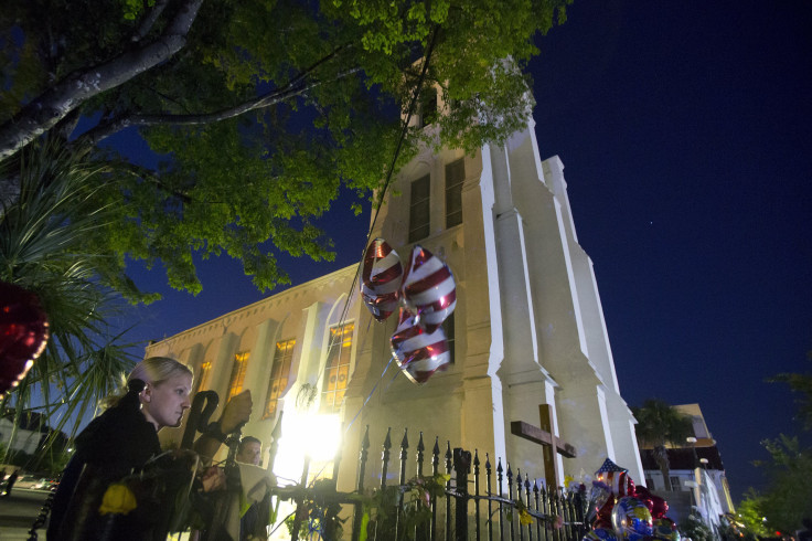 IN PHOTO: A police officer continues to stand guard during a vigil outside Emanuel African Methodist Episcopal Church in Charleston, June 20, 2015.