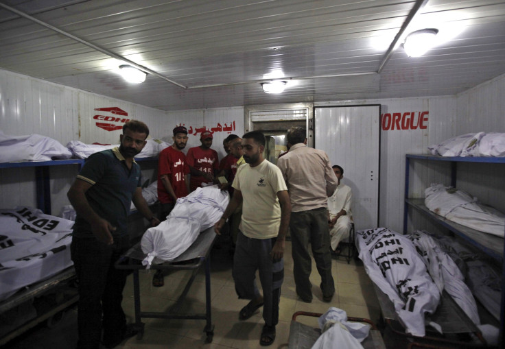 IN PHOTO: Men move the body of a deceased who died due to intense hot weather, after identification at Edhi Foundation morgue in Karachi, Pakistan, June 21, 2015.