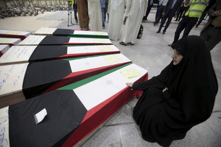IN PHOTO: A woman grieves next to coffins of victims of Friday's bombing at the Imam Sadeq mosque in Kuwait City, at the international airport in Najaf, south of Baghdad, June 27, 2015. 