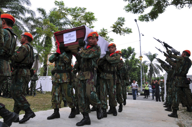 IN PHOTO: Members of the Indonesian Air Force carry the coffin of Sergeant Sugiyanto, who was killed in the crash of an Air Force transport plane in Medan, at a cemetery in Pekanbaru, Riau, Indonesia July 2, 2015