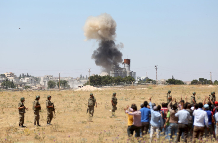 Smoke rises in the Syrian town of Kobani as it is seen from the Turkish border town of Suruc in Sanliurfa province, Turkey, June 25, 2015.