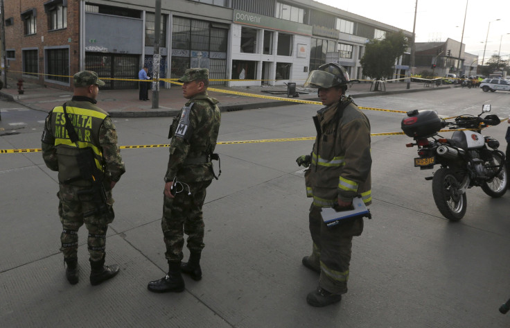 IN PHOTO: Soldiers and a firefighter stand close to the site where an explosion occurred at the office of the Porvenir pension fund in downtown Bogota July 2, 2015