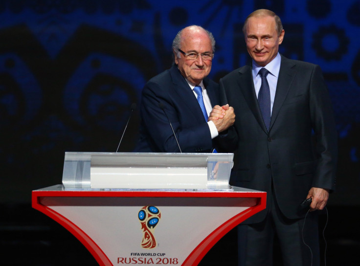 FIFA's President Sepp Blatter shakes hands with Russia's President Vladimir Putin 