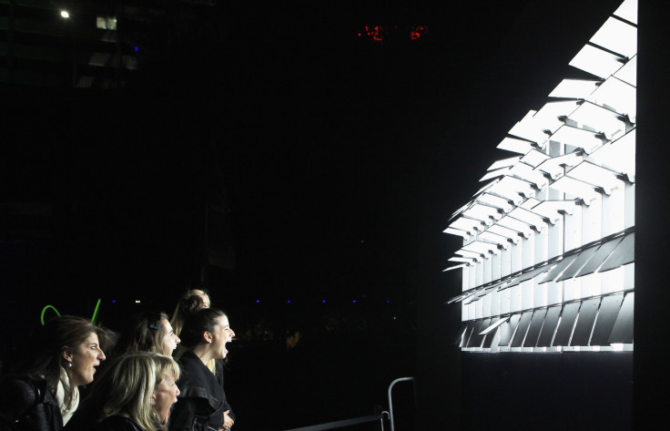 Women interact with "Screaming rapture", a light and sound installation by Liam Ryan, Frank Maguire and Jason McDermott during the Vivid Festival in Sydney May 27, 2012. Vivid Sydney, a festival of light, music and ideas, will run until June 11.