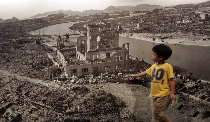 A boy looks at a huge photograph showing Hiroshima city after the 1945 atomic bombing, at the  Hiroshima Peace Memorial Museum, Japan August 6, 2007. 