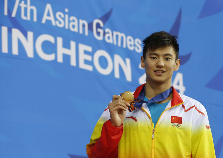 Gold medallist Ning Zetao of China holds his medal on the podium at an award ceremony.