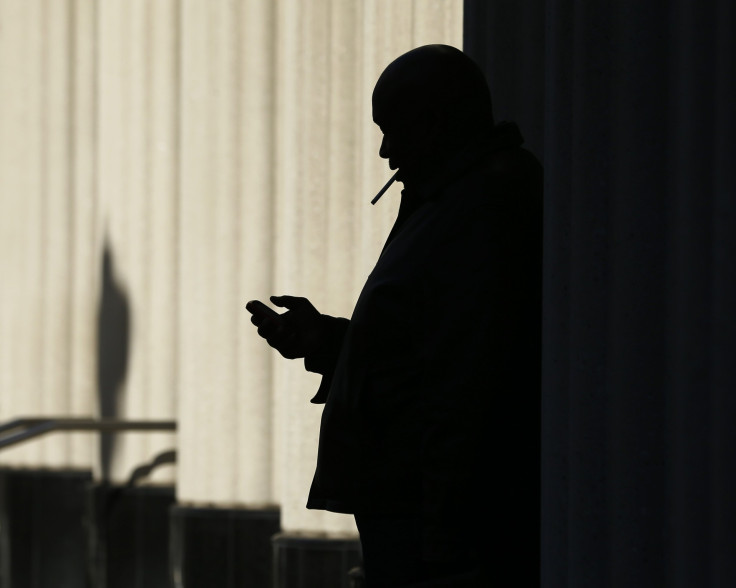 Man texting in the dark