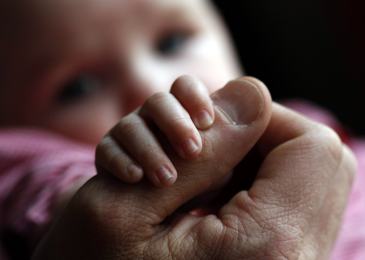 Holding father's thumb 