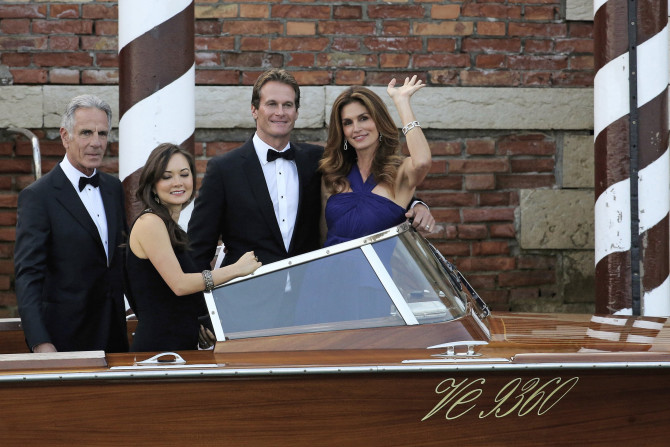[13:42] U.S. model Cindy Crawford (R) waves next to her husband Rande Gerber (2nd R) as they take a taxi boat