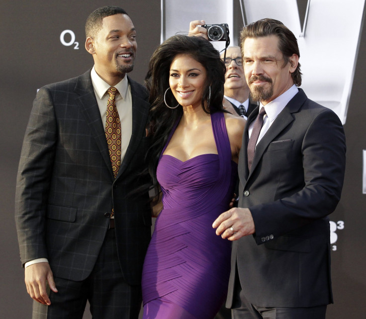 Cast members Will Smith (L), Nicole Scherzinger, Josh Brolin (R) and director Barry Sonnenfeld (background) pose on the red carpet for the German premiere of their film "Men in Black III" in Berlin May 14, 2012. 