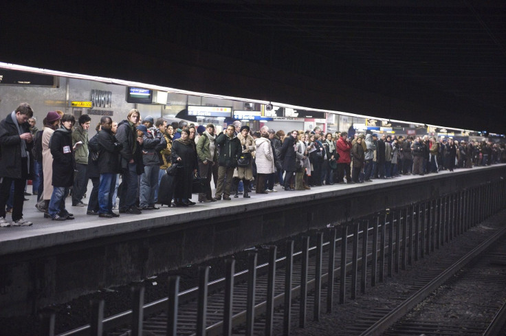 Commuters wait on a platform for their regional train in a station in central Paris