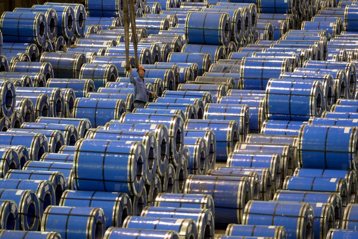 An employee works among stainless steel sheets at a steel factory in Taiyuan, Shanxi province, China, September 2, 2015.