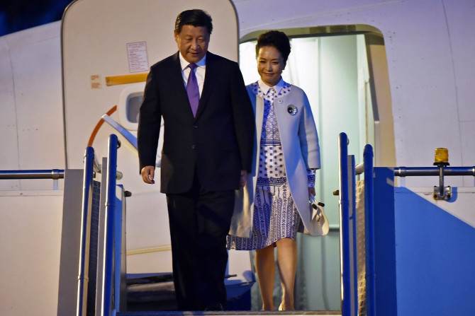 China?s President Xi Jinping walks with his wife Peng Liyuan