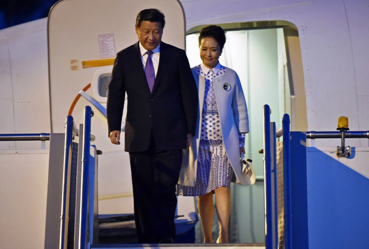 China?s President Xi Jinping walks with his wife Peng Liyuan