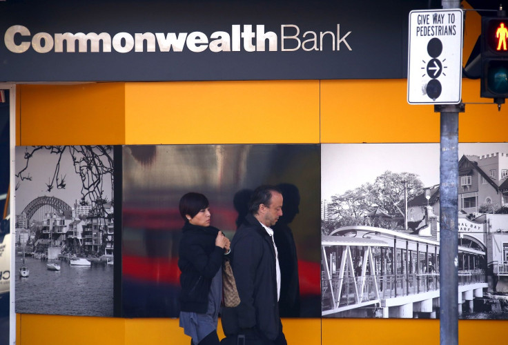People walk out of a Commonwealth Bank of Australia branch in Sydney, Australia, August 12, 2015.