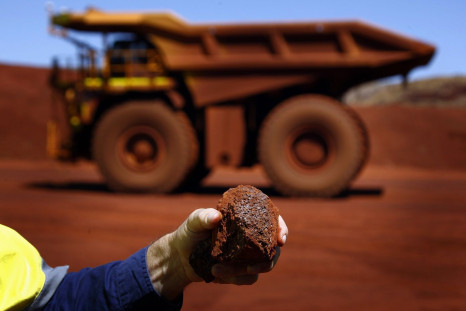 Fortescue Chief Executive Officer (CEO) Nev Power holds a piece of iron ore