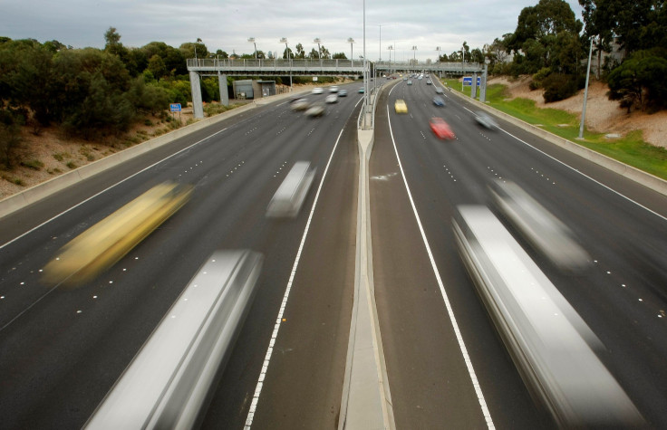Cars and trucks pass through an electronic toll gate on a motorway in Melbourne June 24, 2008.