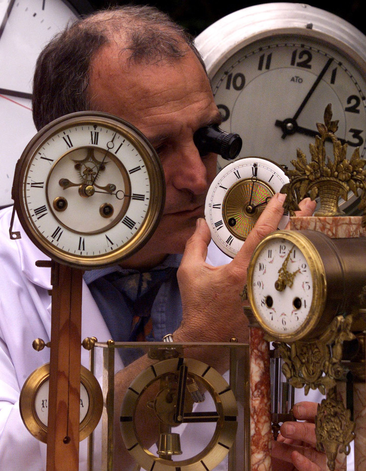 Watchmaker adjusts clock